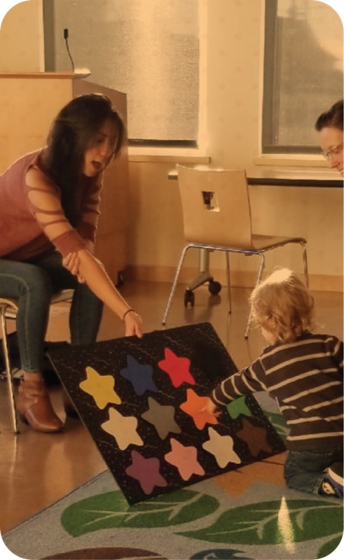 Teacher showing colors to children in classroom